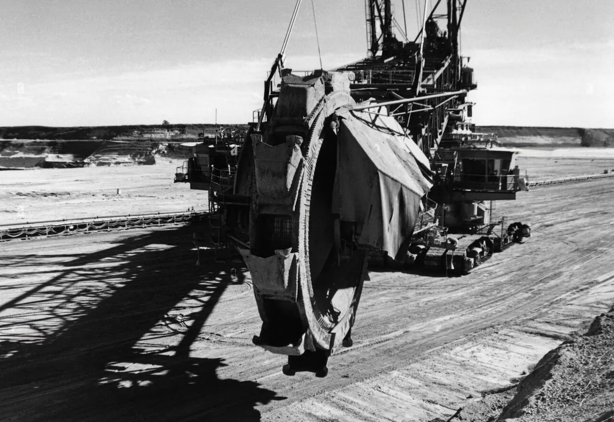 Early 1920s construction equipment — excavators and cranes at a worksite