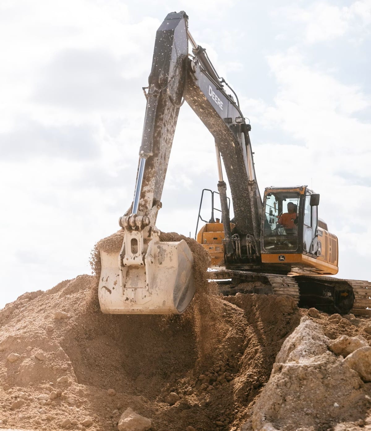 Excavator scooping dirt at a construction site