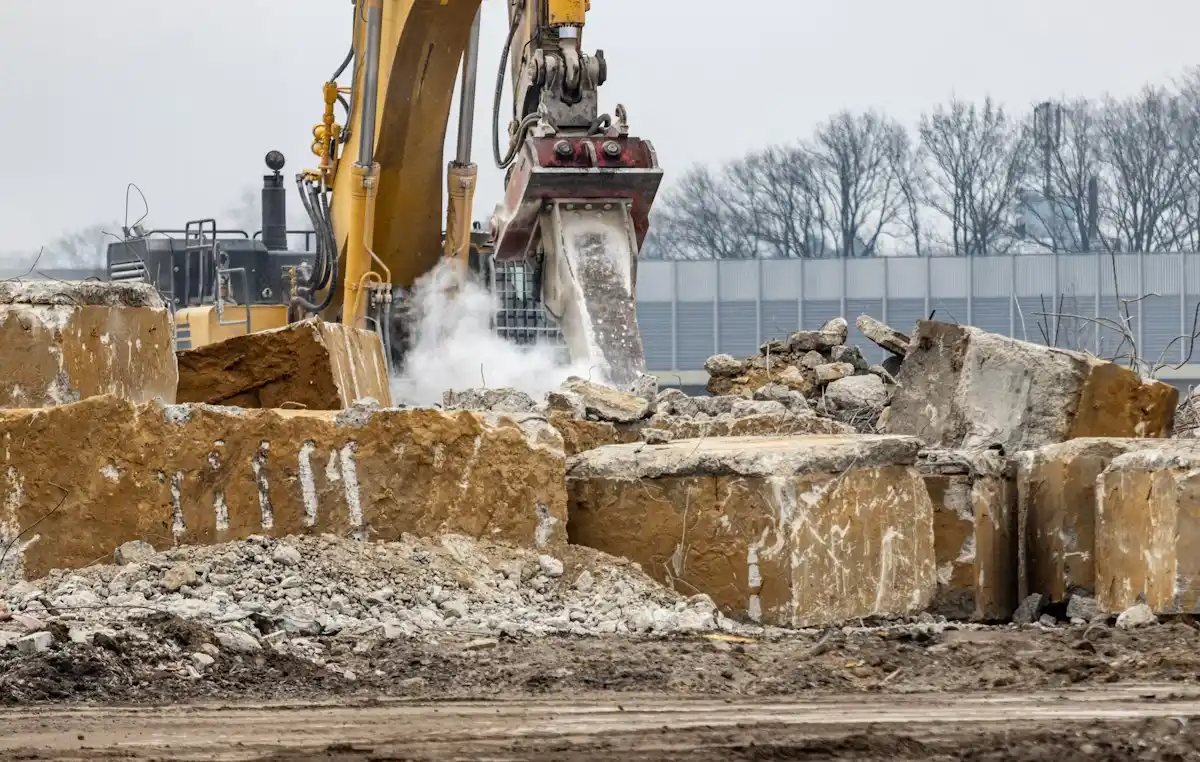 Bulldozer clearing rubble at a demolition site