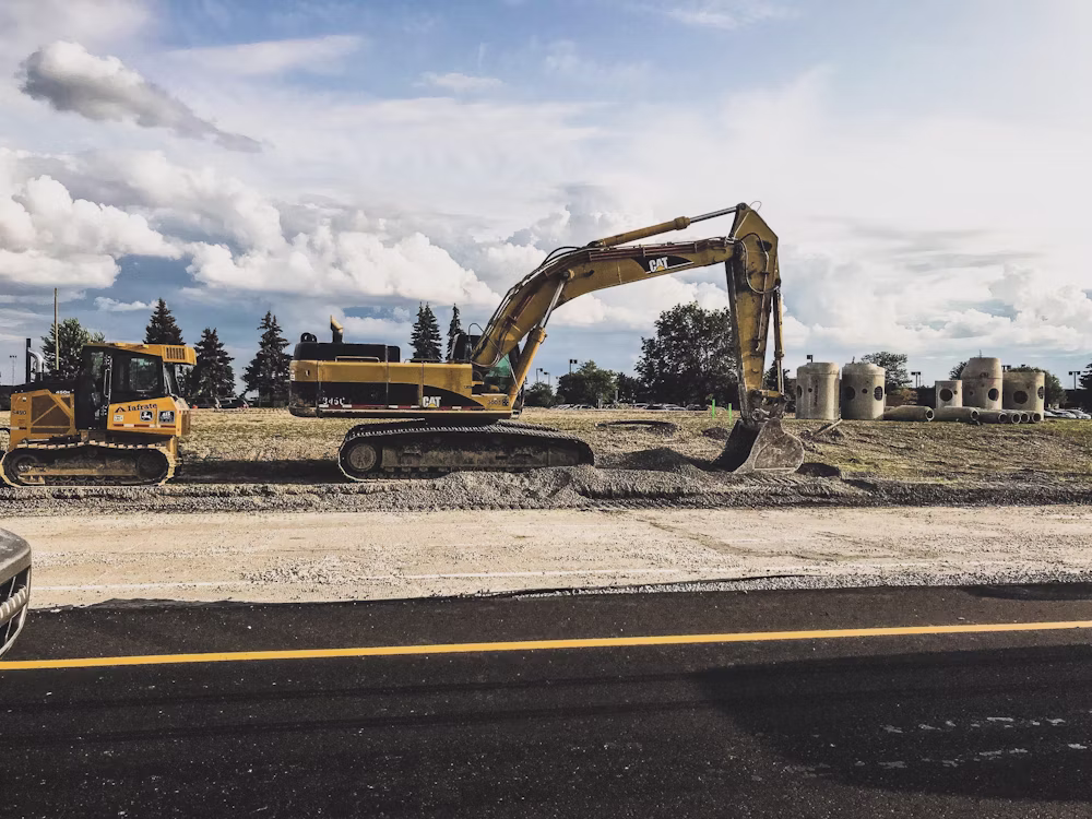 Excavator clearing land at a development site